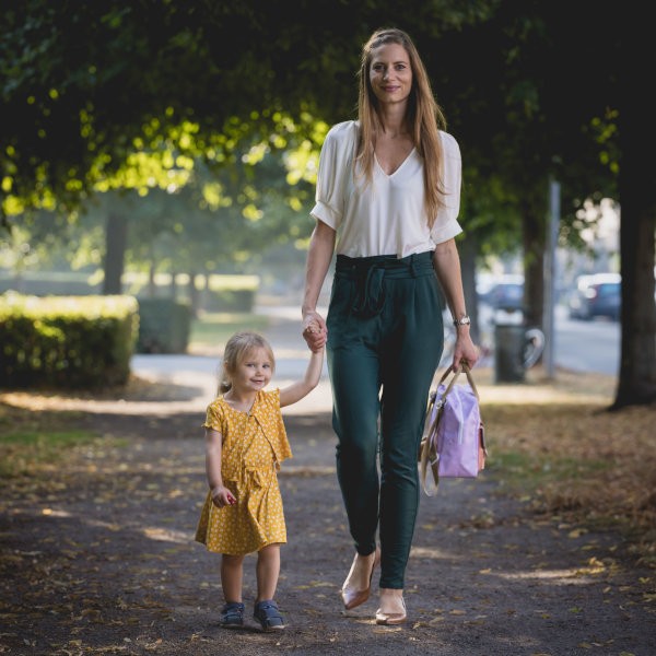 A woman and a child holding hands