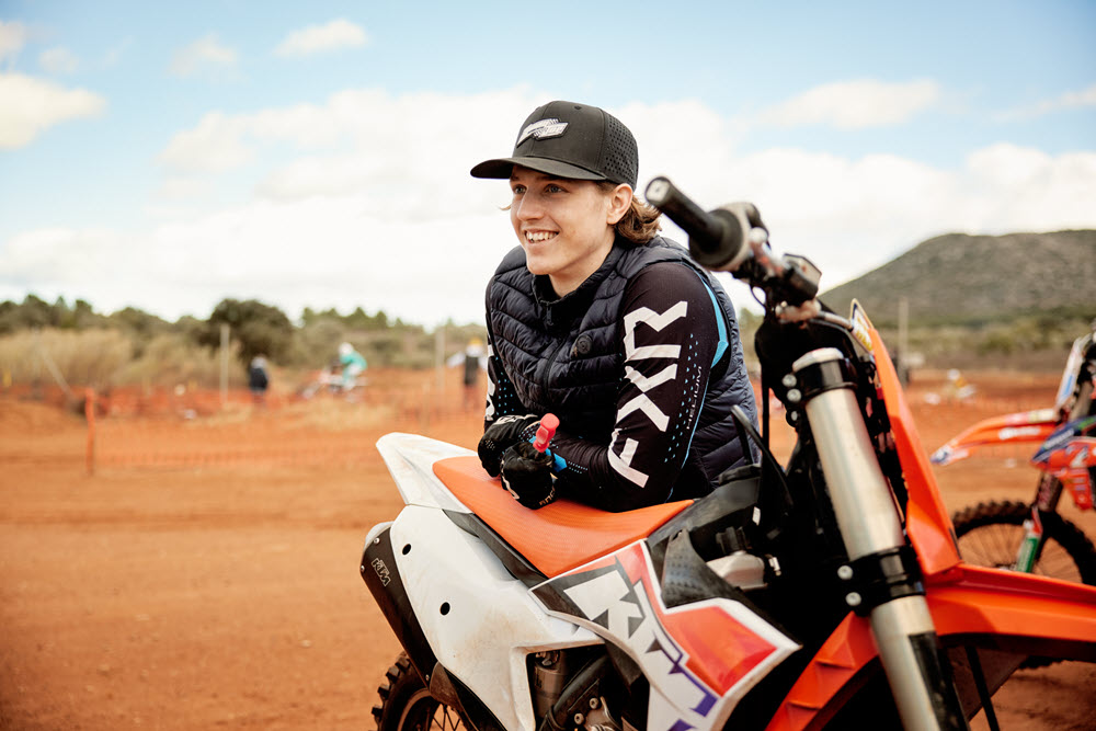 William leaning against his bike smiling