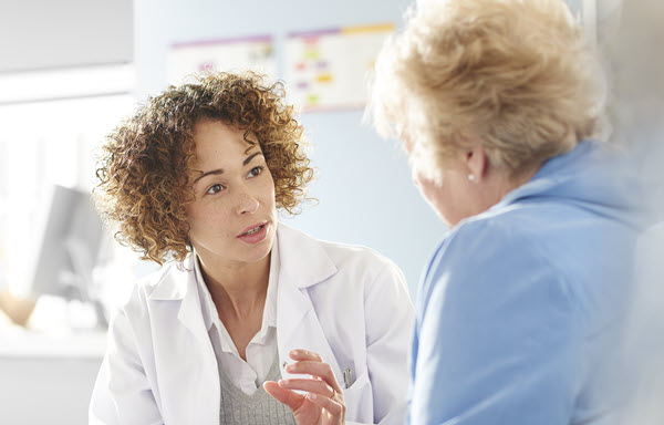 Older woman in dialogue with healthcare professional