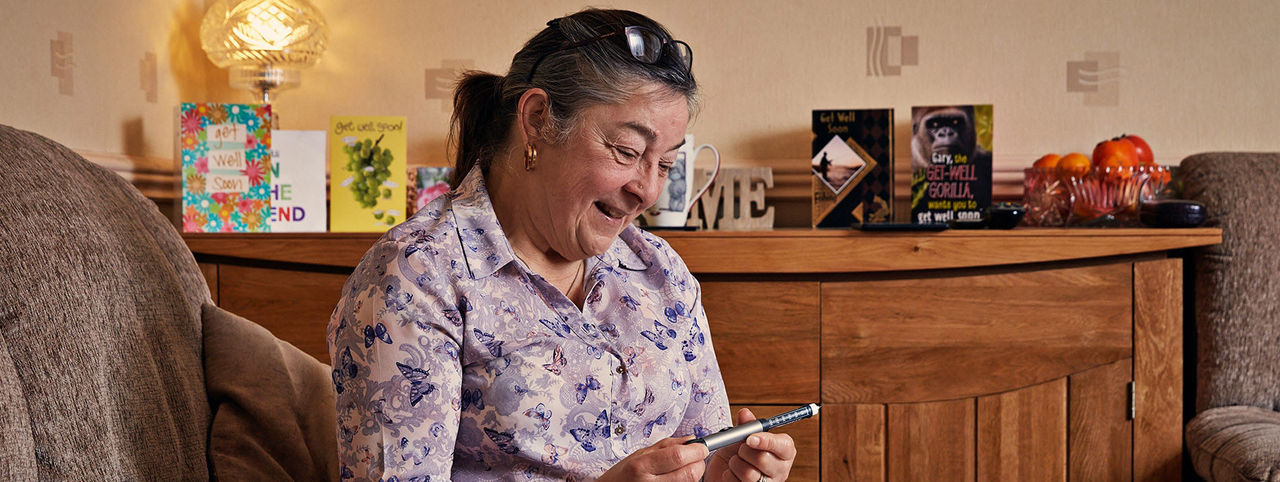 Woman holding a pen device