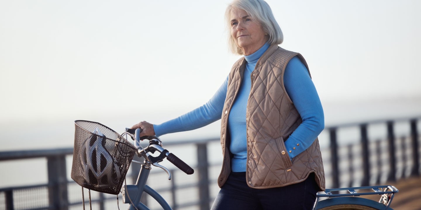 Woman holding her bike - not real patient