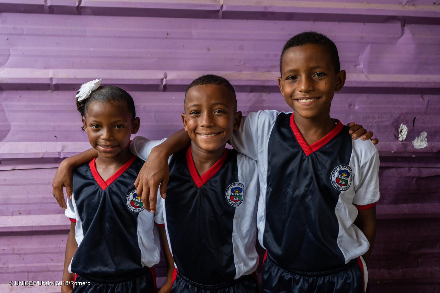 Photo of three young persons smiling