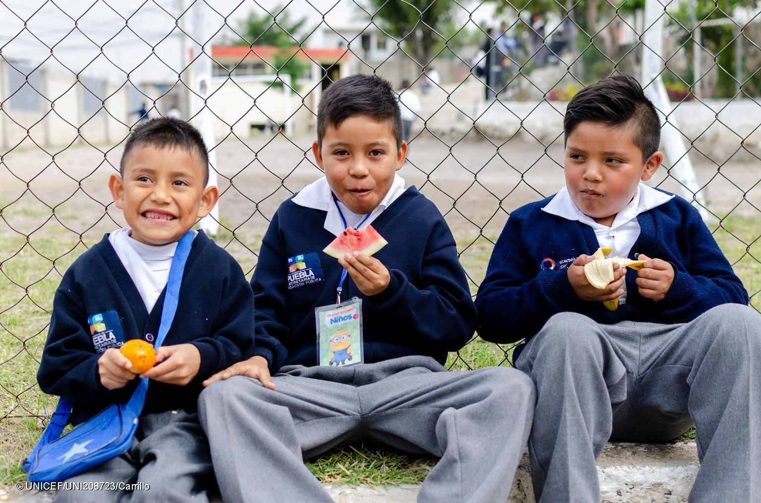 photo of three children eating lunch