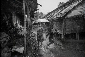 Two people standing in the rain
