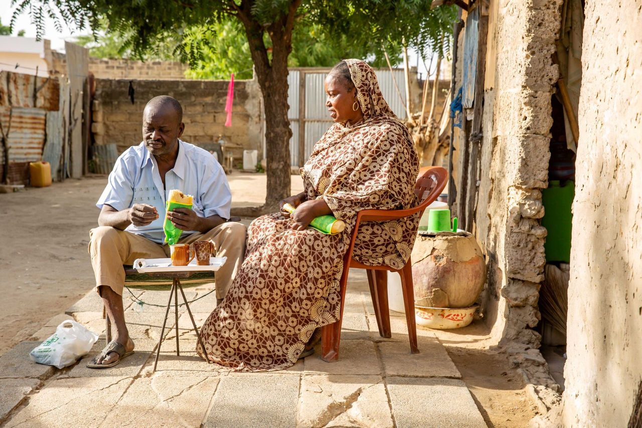 Man and woman sitting outside on the porch