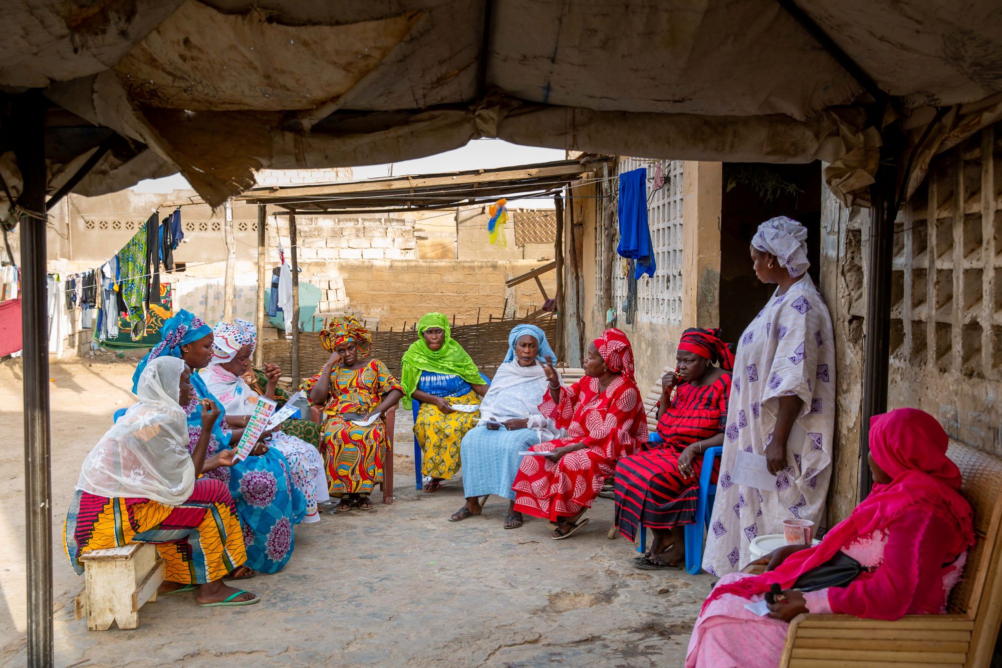 Image of a group of women in colorful dresses talking