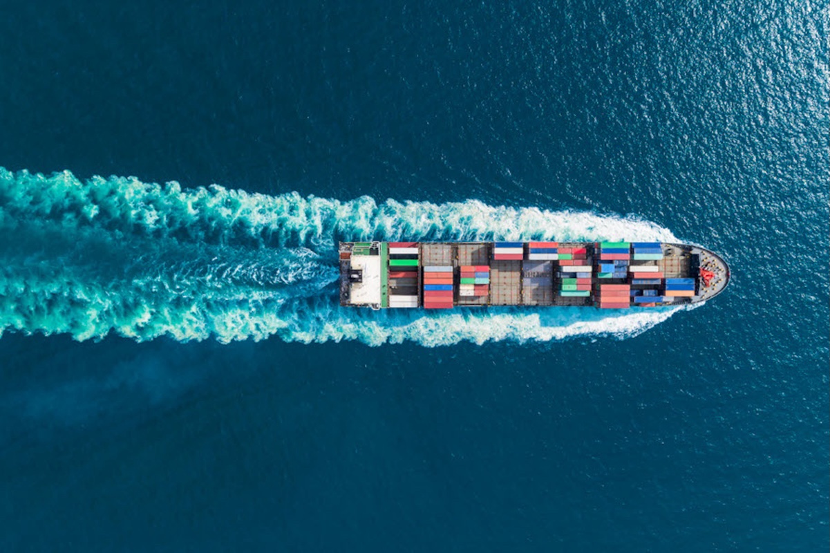Image of a container ship traveling across the ocean